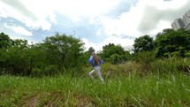 woman running through a field 