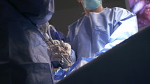 Surgeons working during surgery, close up on hands and instruments.