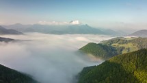 Fly above foggy clouds in mountains valley Time lapse
