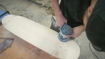 man sanding wood 