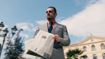 Business Man With Briefcase And Newspaper