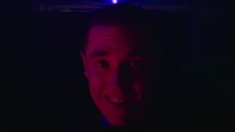 face of a man dancing in a club 