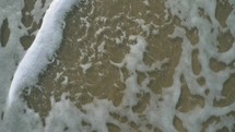 tide washing onto a beach 
