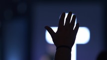 A mans hand raised in praise at a church service