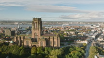 Majestic Liverpool Cathedral overlooking the city and river aerial sunset