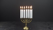 blow out a menorah with seven candles