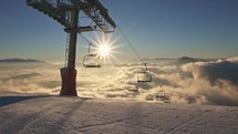 Beautiful weather for skiing in winter ski alpine mountains resort with empty chairlift and fresh groomed snowy slopes
