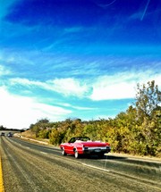 Red corvette on highway