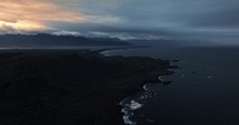 Aerial Coastal View Of Iceland, Waves Crashing Into Rocky Beach, Sunset Clouds