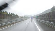 vehicle traveling on a wet road in the rain 