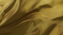 wrinkled gold fabric waving 