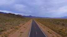 Aerial of a desolate road in a desert landscape