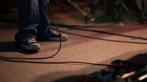 feet of a musician on stage 