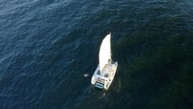 Aerial view of sailing luxury yacht at opened sea on a sunny day