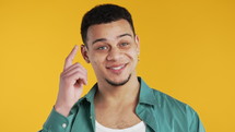 Handsome african american brainy man with gesture - you, think about it. Looking camera on yellow. Thinking positive. Intelligent person with curly brunette hair. High quality 4k footage