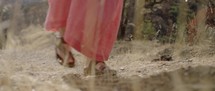 Biblical-era woman walking up a hill