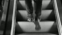 a man walking up escalator stairs 