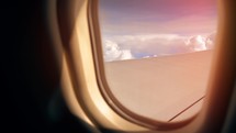 Sunset and Journey from the Airplane Window. Plane Flights Over Fluffy Clouds. Passenger window panorama view.