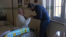 son greeting his father at a nursing home 