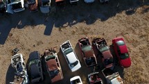Aerial flyover of old cars in a junkyard