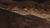 Tourist walking up a hill in Death Valley