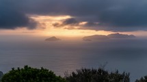 Dark clouds over ocean coast at golden sunrise in summer morning Time lapse
