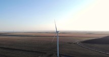 Aerial drone shot of Windmill For Electric Power Production On The Field. 
