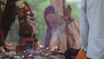 Burning incense and worshiping at Hindu idols at an altar at The Varaha Lakshmi Narasimha Hindu temple. 