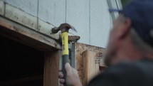Man repairing a wooden door