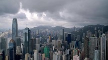 Drone aerial shot of modern skyscrapers in Hong Kong. Storm clouds.