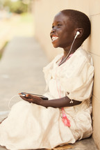 joyful child listening to music on an iPod