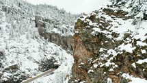Drone footage of a highway tunnel in the snow covered Colorado Rocky Mountains.
