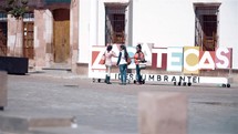 women on a sidewalk in Mexico 