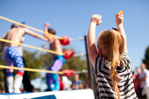 Child cheering at wrestling match