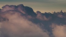 Winter mountains hidden in clouds sky at sunset in snowy nature Time lapse
