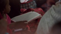 Christians in India reading their Bibles in a house church in a small village outside the city of  Vizag Visakhapatnam, India.
