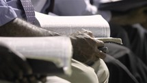 reading Bibles during a worship service 