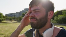 Sleepy Man Wakes Up After A Nap On A Park Bench