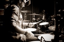 a man playing a drummer on stage 