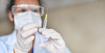 scientist holding a syringe 
