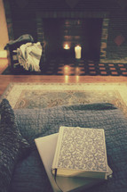 books in a chair by a fireplace 
