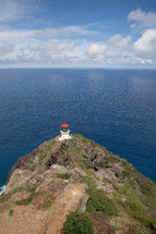 lighthouse on a cliff overlooking the ocean 