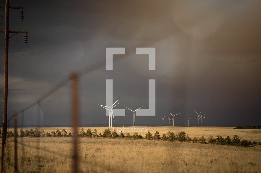wind turbines in a stormy field 