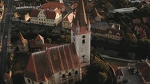 aerial view over a cathedral and town 