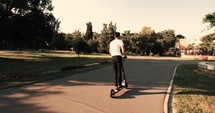man on a scooter in a park 