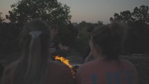 roasting marshmallows around a campfire 