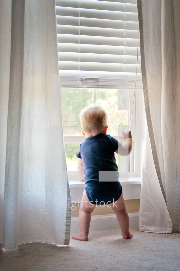 infant boy in a window 