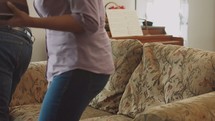 man and woman sitting down at a couch and opening their Bibles at a Bible study