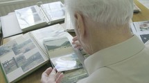 senior man looking through a photo album 