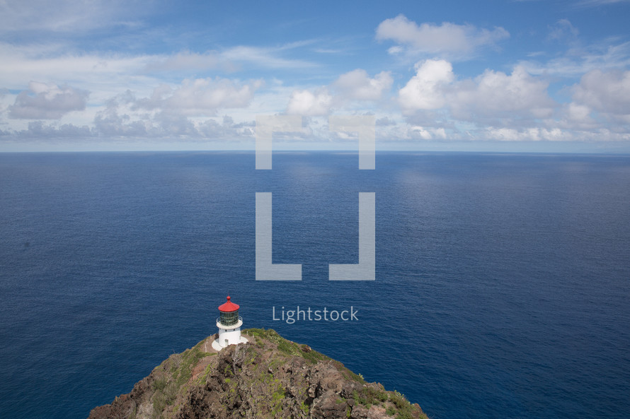 lighthouse on a cliff overlooking the ocean 